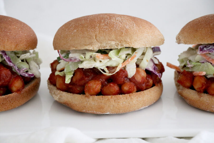 3 bbq chickpea burgers topped with coleslaw.